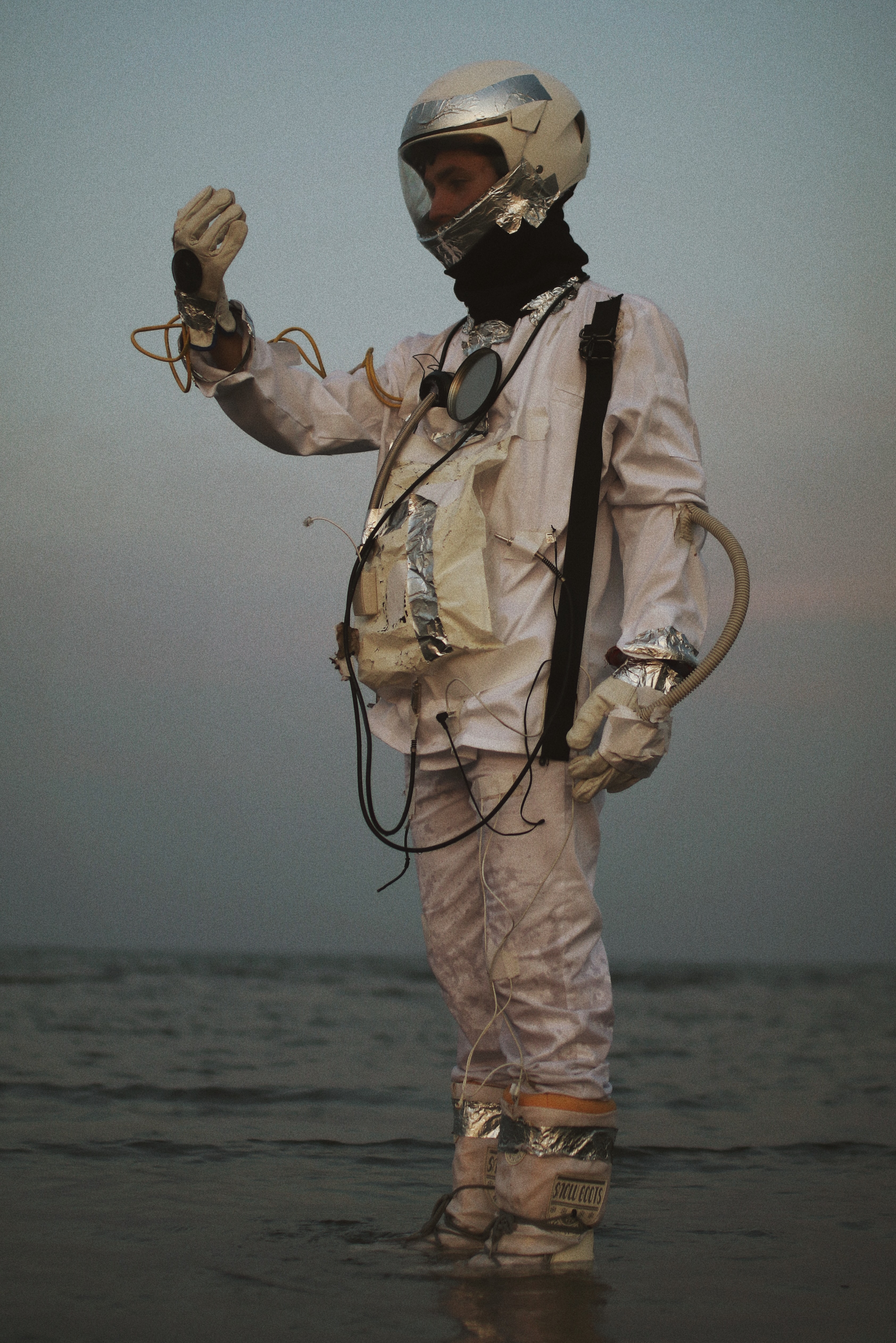Astronaut standing on gray sand